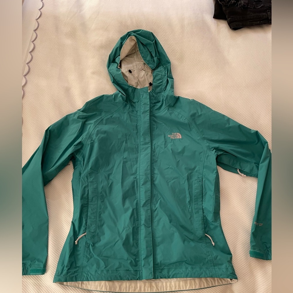 Green north face rain coat
